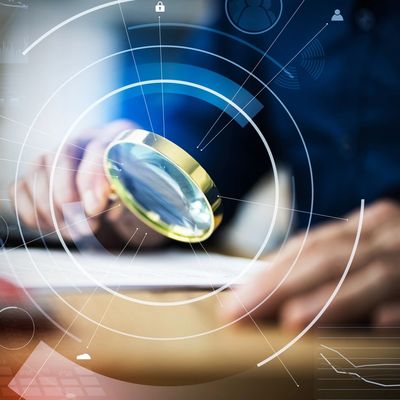 Business Auditor Using Magnifying Glass For Paperwork Fraud Investigation