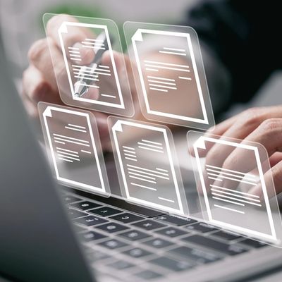 Businessman working on laptop computer with electronics document icons