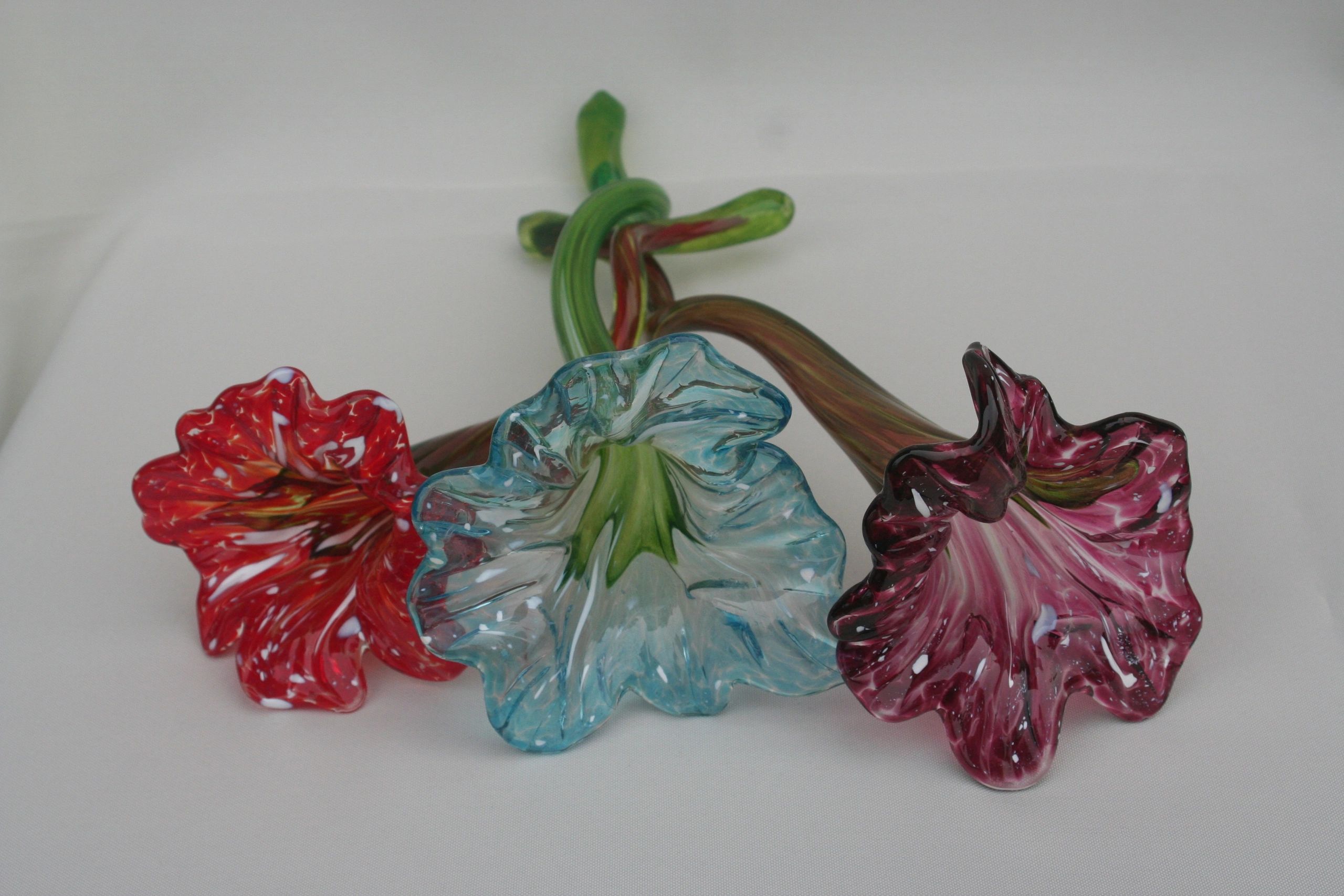 Glass Flowers made to lay down or stand up in a vase.   These come in many different colors