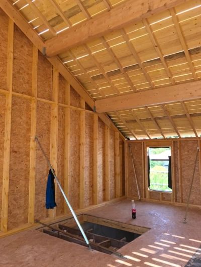 Intérieur en bois en construction avec une ouverture au sol.