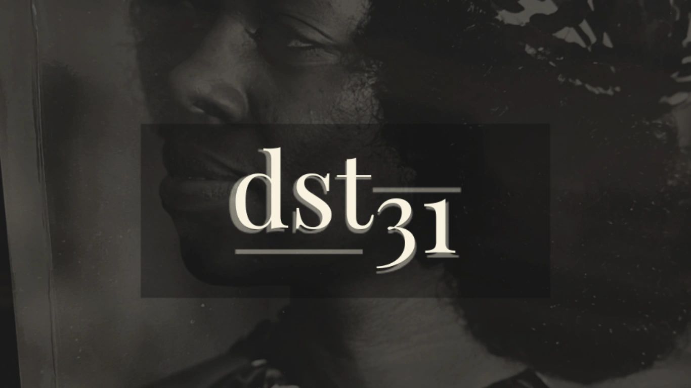 Stack of books next to pencils in a holder and a camera.