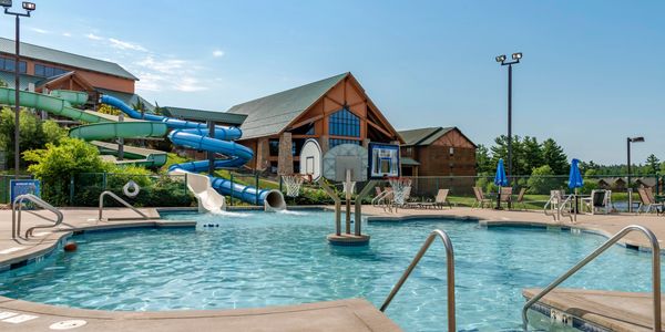 Outdoor waterpark activity pool with basketball hoops