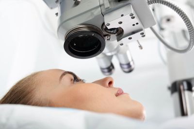 A patient undergoing an eye examination with advanced medical equipment.