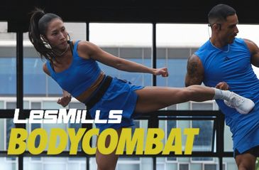Two athletes performing a high kick workout in Les Mills Bodycombat.