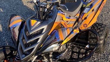 Close-up of a colorful Yamaha Raptor 700R quad bike with special edition decals.