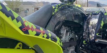 Close-up of a vibrant yellow and black ATV with unique decals.