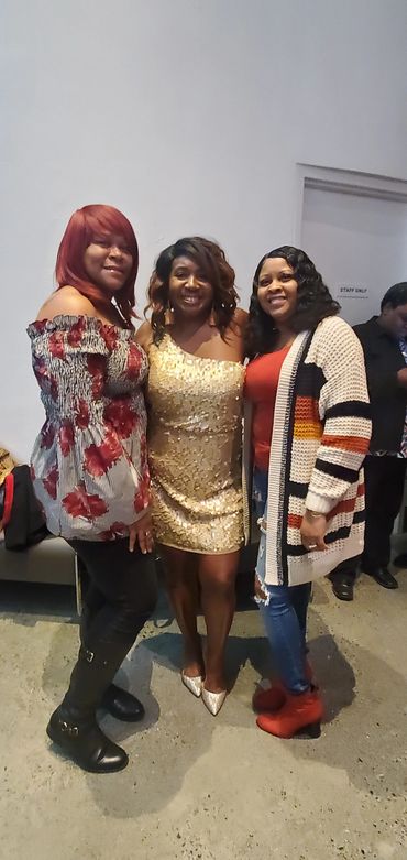 Three women posing with formal outfits