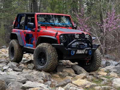 A Jeep driving over rocks