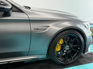 Close-up of a sleek Mercedes-Benz V8 Biturbo wheel and side emblem.