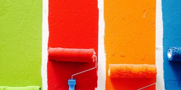 paint rollers with paint on them painting walls