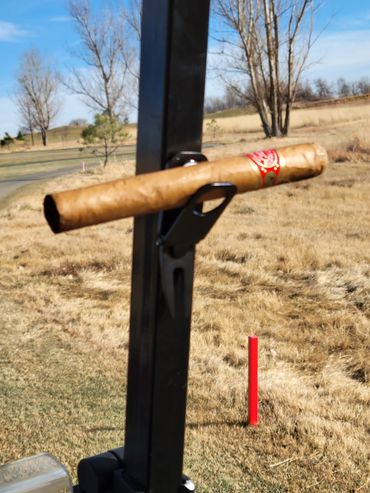 Magnetic cigar holder on a golf cart.