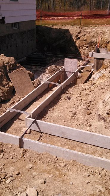 Wooden framework set for concrete foundation at a construction site.