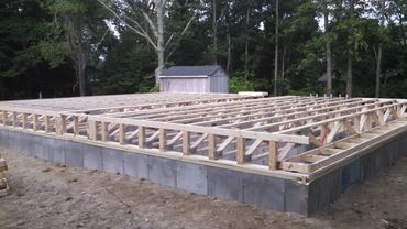 Wooden framework for a building foundation under construction.
