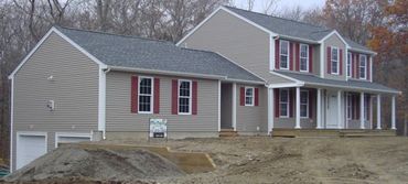 Newly built two-story house with attached garage and beige siding.