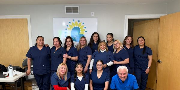 Group of healthcare professionals posing together in a room.