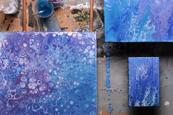 Abstract paintings from liquid acrylic in the artist's studio