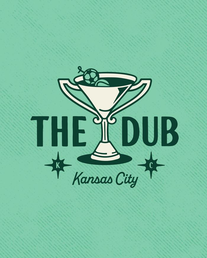 a martini glass that also looks like a trophy with the words The Dub around it.