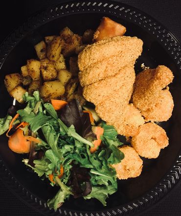 Fried Catfish with roasted potatoes and salad.