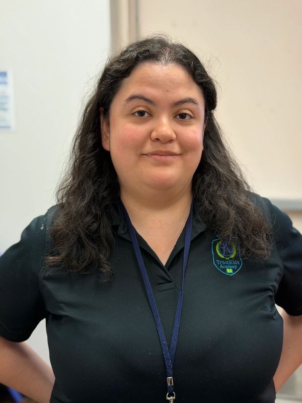 Woman with dark hair and black shirt smiling gently.