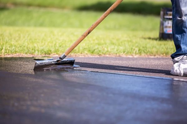 Applying sealcoat with a squeegee
