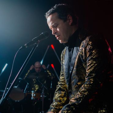 A photo of the band Re-Release performing live.