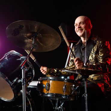 A photo of the band Re-Release performing live.