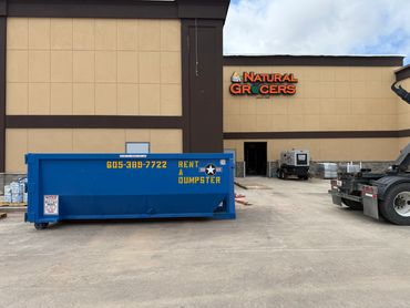 20-yard roll off dumpster at a commercial new construction site