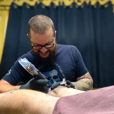 Brandon Price, a skilled tattoo artist tattooing at Inksane Asylum Tattoo in Pensacola, Florida. 