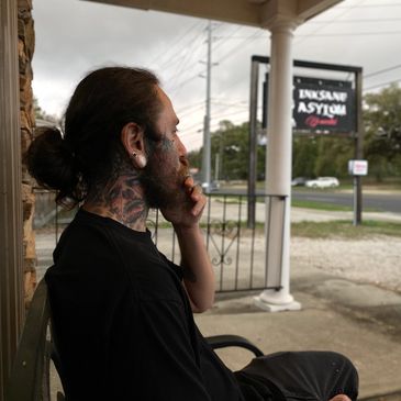 Gavin Shanks, a skilled tattoo artist tattooing at Inksane Asylum Tattoo in Pensacola, Florida. 