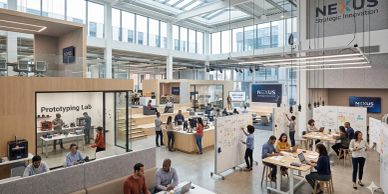 A modern, spacious innovation lab with people collaborating and working on projects.