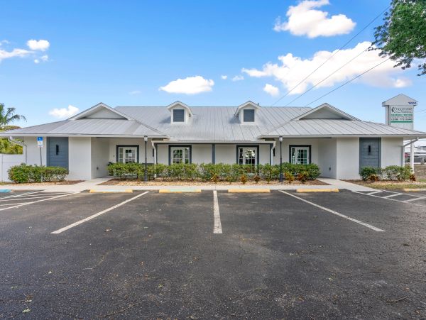 Single-story office building with parking lot.