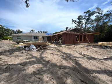 House under construction with clear sky.