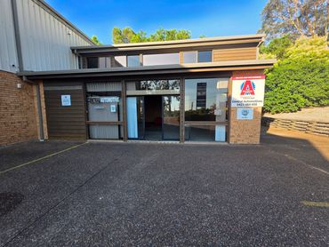 Exterior of Central Automotive workshop with clear signage and a blue sky.