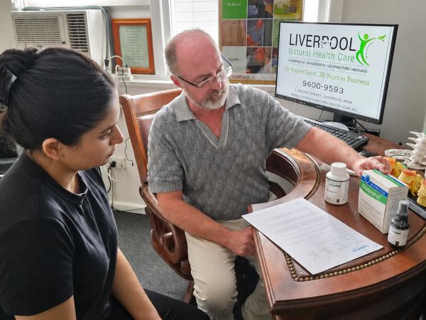 Doctor consulting a patient in a natural health care setting.