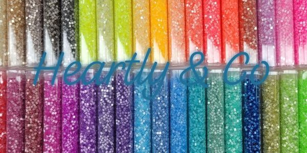 Rows of colorful glitter tubes arranged in a gradient.