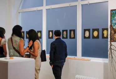 People talking and looking at artwork.