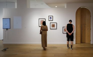 Spectators looking at Luna Hao's artwork.