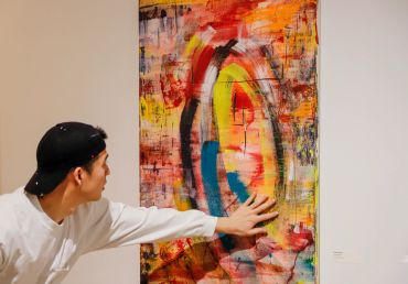 Artists touching his artwork.