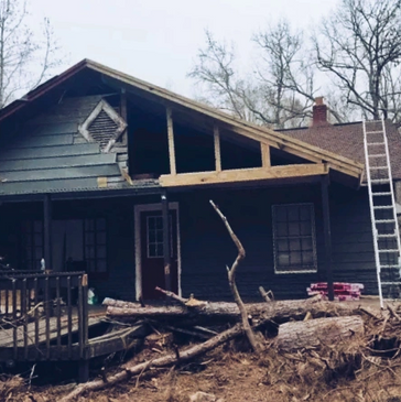 Craftsmen restoring a home with extensive damage to the roof.