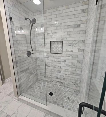 Newly constructed tile shower with custom niche.