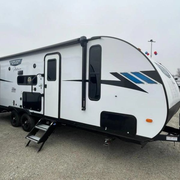 Photo showing exterior front passenger side, including entry door and outdoor kitchen area.