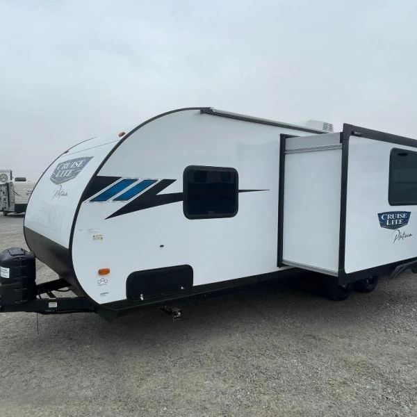 This is the exterior from the drivers side front corner, shows the dinette slide out, as well as bed