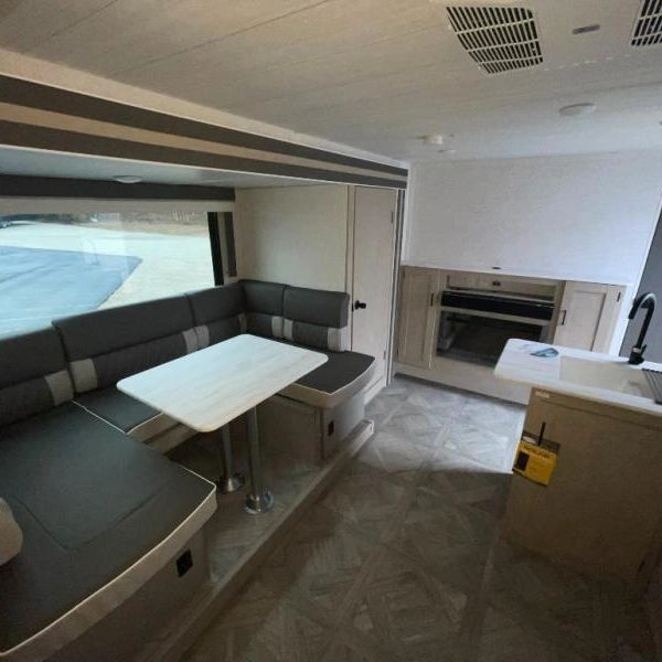 Photo showing the spacious u-shaped dinette in the slide out with the large panoramic window on the