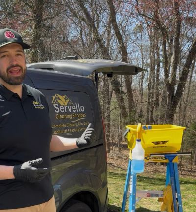 commercial cleaning business owner standing by professional van with logo