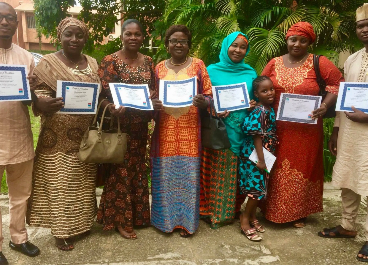 Attendees of a presentation holding their certificates.