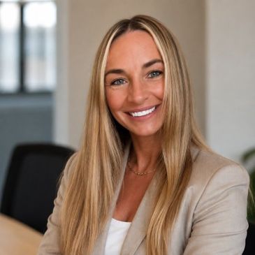 Smiling woman with long blonde hair wearing a beige blazer.