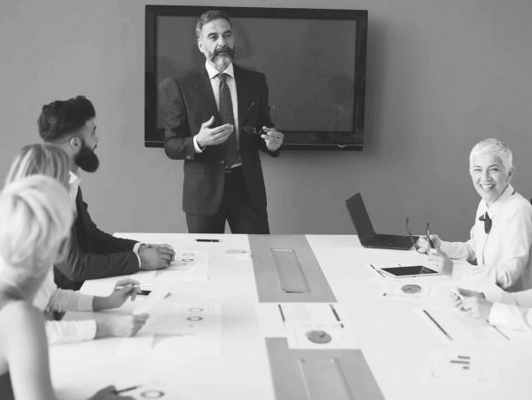 Businessman giving presentation in meeting room.