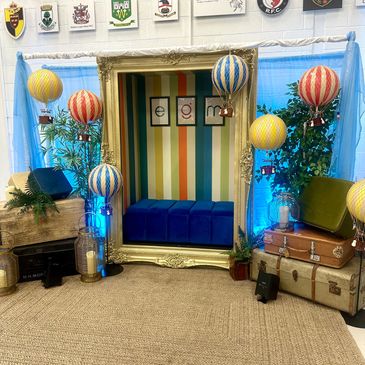 Cozy vintage-themed photo booth with hot air balloon decorations.