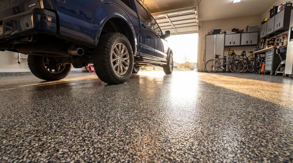 Finished garage floor with truck, bikes and workstation