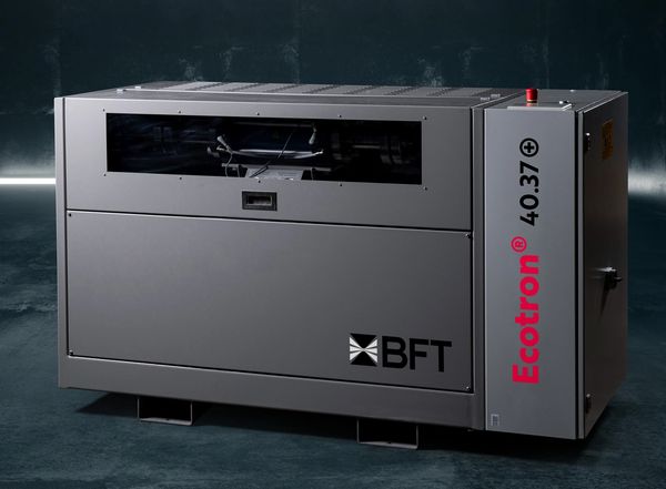 A modern BFT Ecotron 40.37 industrial machine in a dark room with neon lights.